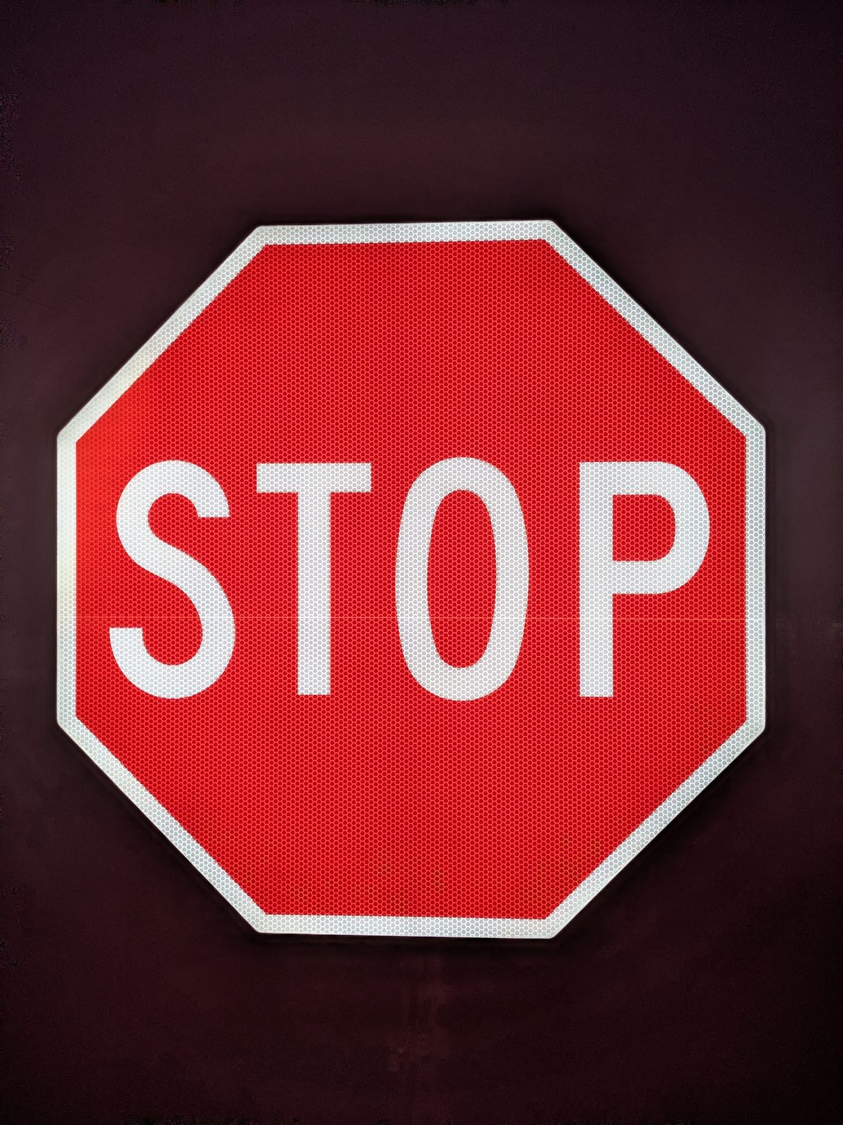 APEX I Alpha Unit R1-1 STOP sign, lit, front view before sunrise